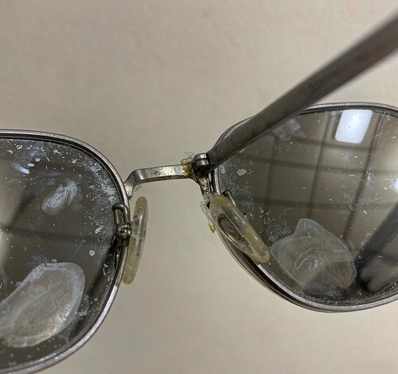 Dirty eyeglasses with fingerprints and skin oil buildup